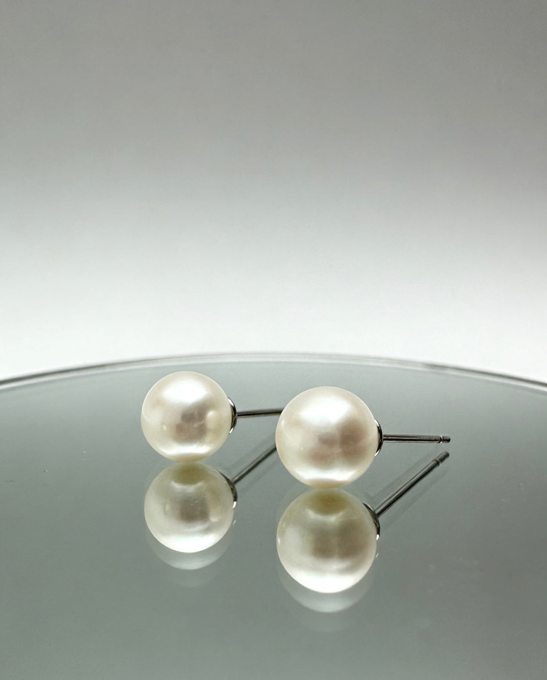 7mm round fresh-pearl earrings  on glass