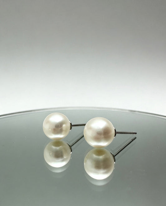 7mm round fresh-pearl earrings  on glass