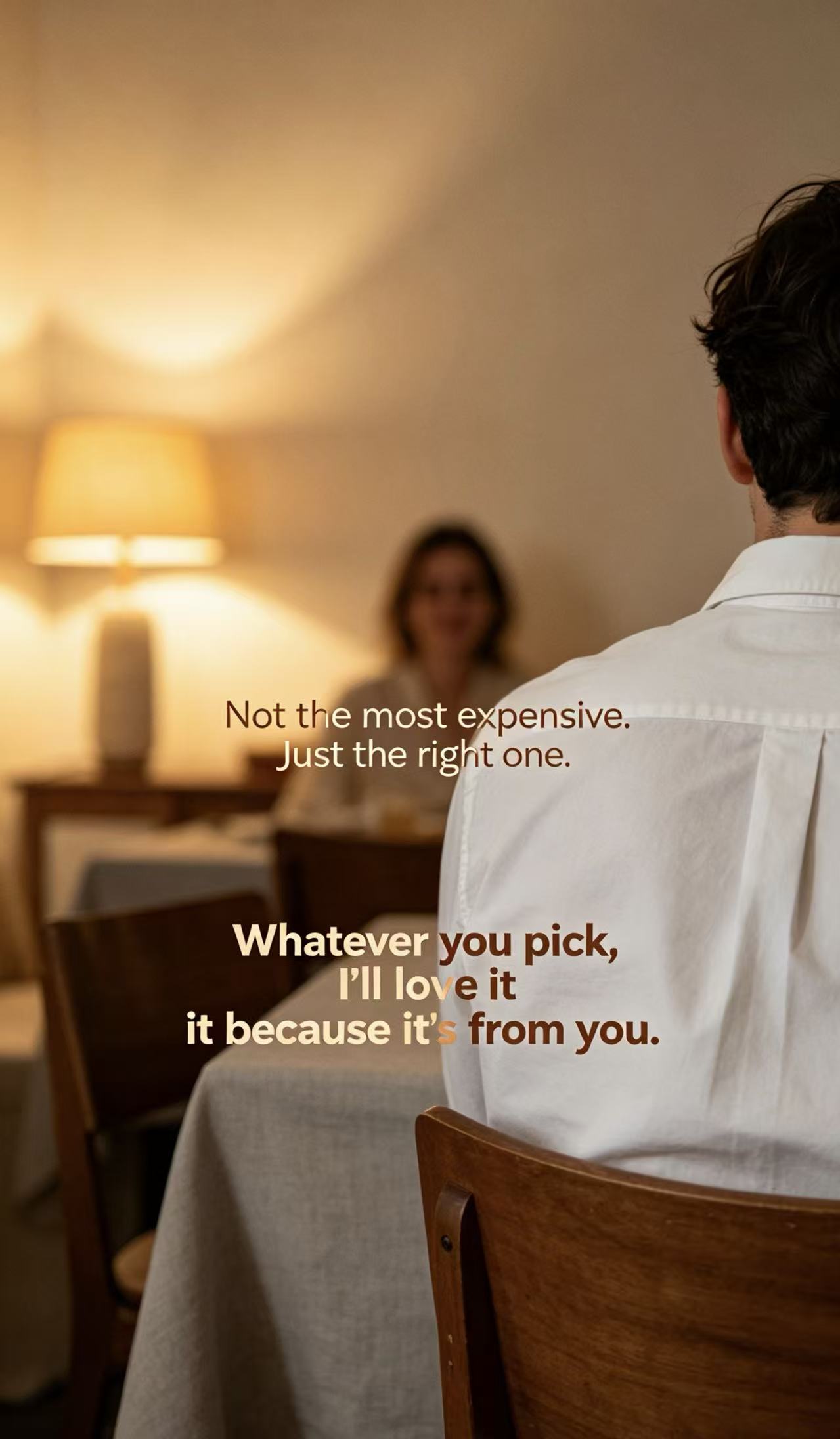 Man at a candlelit dinner, facing away from the camera, with a woman blurred in the background.