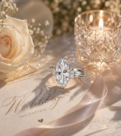 Silver 3.0ct D color VVS1 marquise moissanite three-stone engagement ring on a wedding invitation.