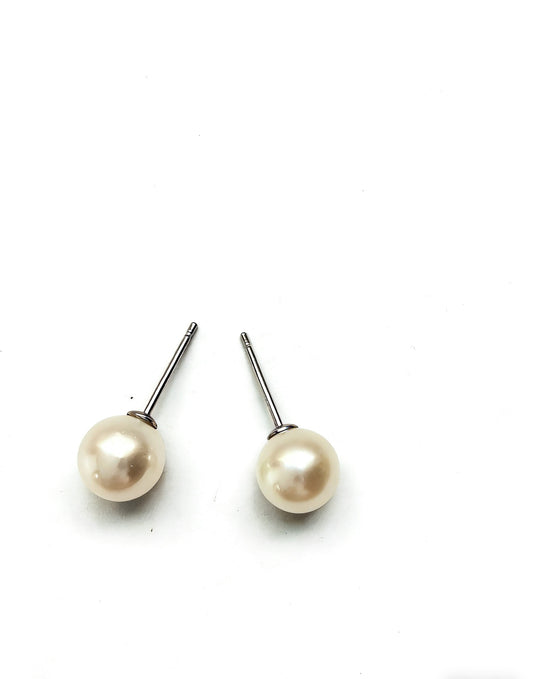 Pair of 7mm natural freshwater pearl stud earrings with sterling silver posts on a white background.