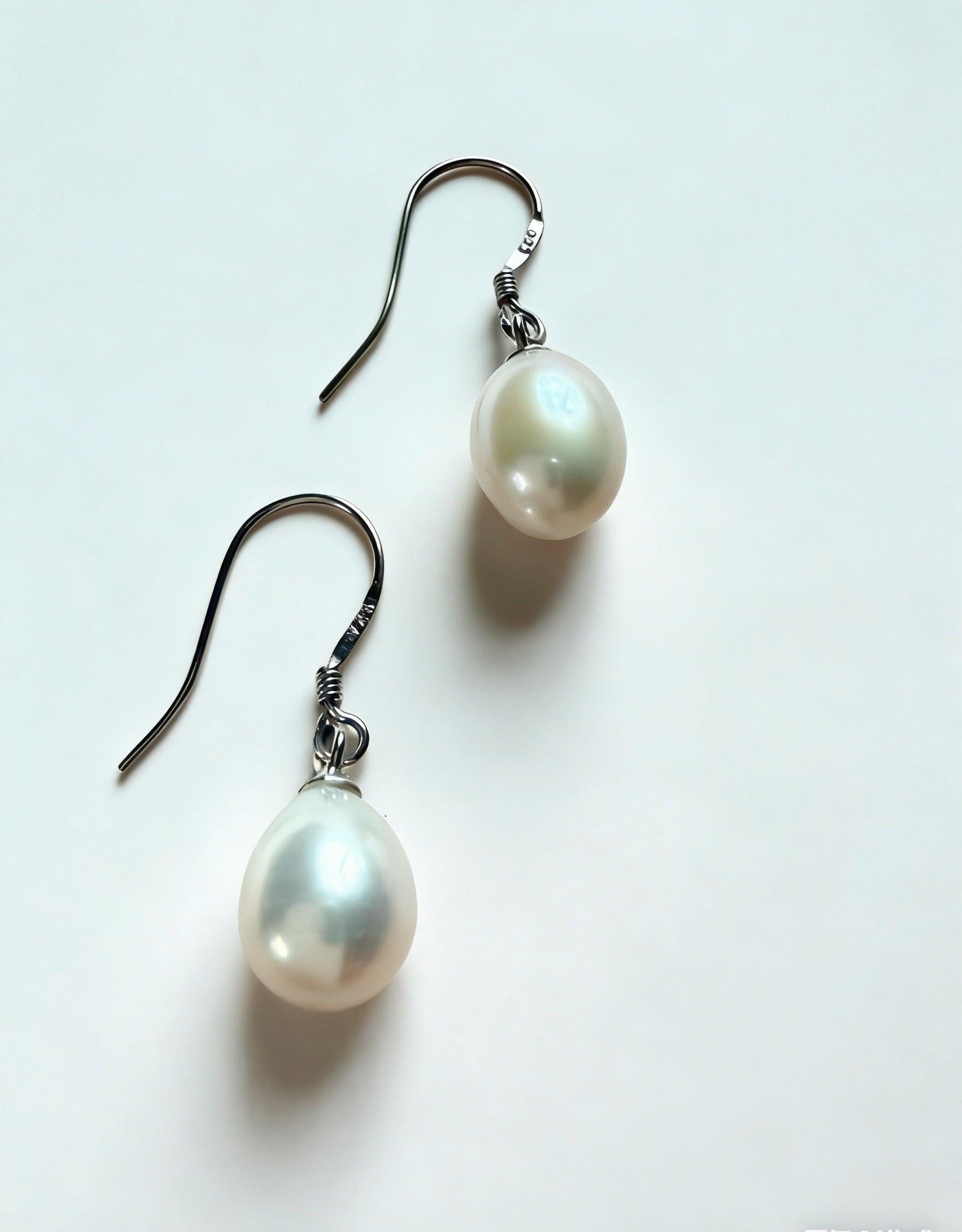 Baroque freshwater pearl drop earrings with 7-8mm natural white pearls and 925 sterling silver hooks.