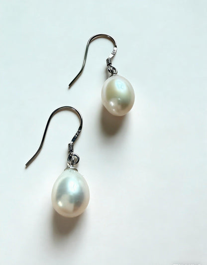 Baroque freshwater pearl drop earrings with 7-8mm natural white pearls and 925 sterling silver hooks.