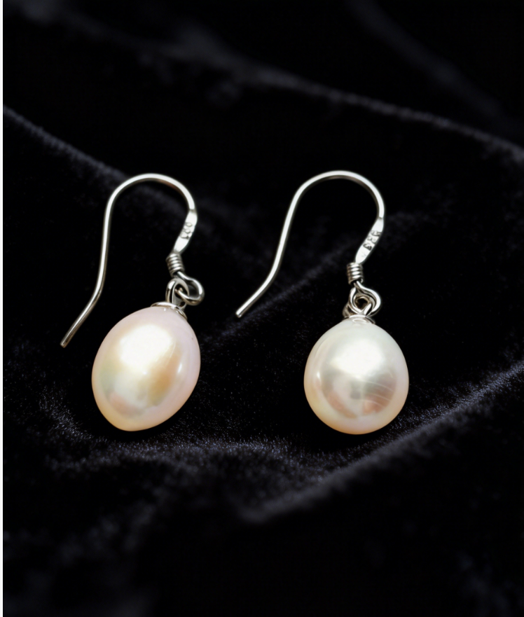 Baroque freshwater pearl drop earrings with 7-8mm natural white/cream pearls on 925 sterling silver hooks.