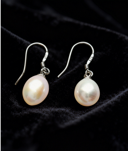 Baroque freshwater pearl drop earrings with 7-8mm natural white/cream pearls on 925 sterling silver hooks.
