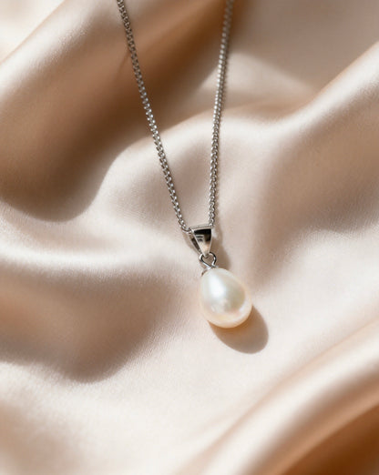 Baroque freshwater pearl pendant necklace with a cream-white pearl and 925 sterling silver chain on silk.