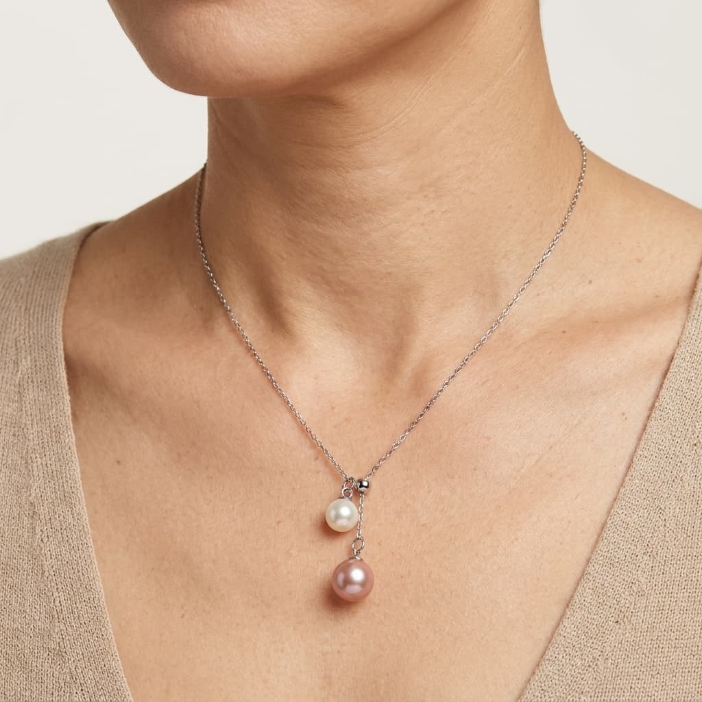 Double freshwater pearl pendant necklace with peach pink and white pearls on a sterling silver chain.