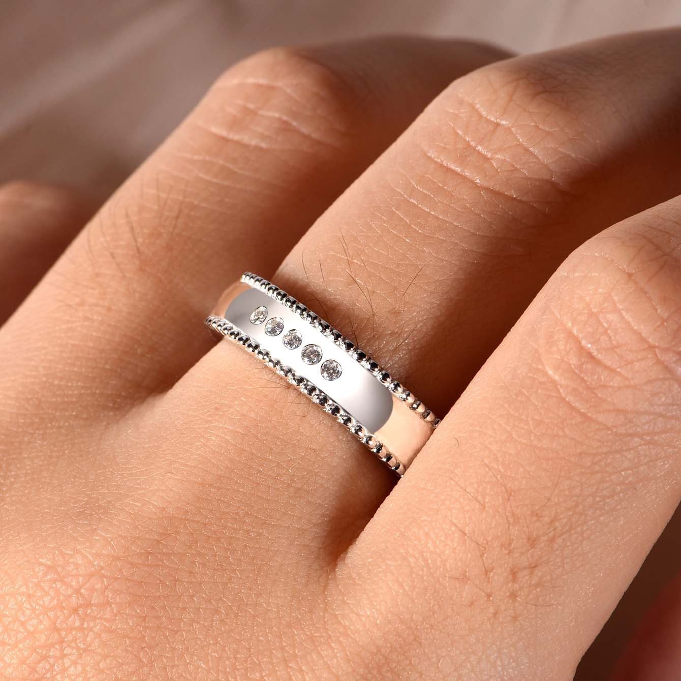 Men's wide S925 silver moissanite wedding ring with beaded edges and five D-color VVS1 stones.