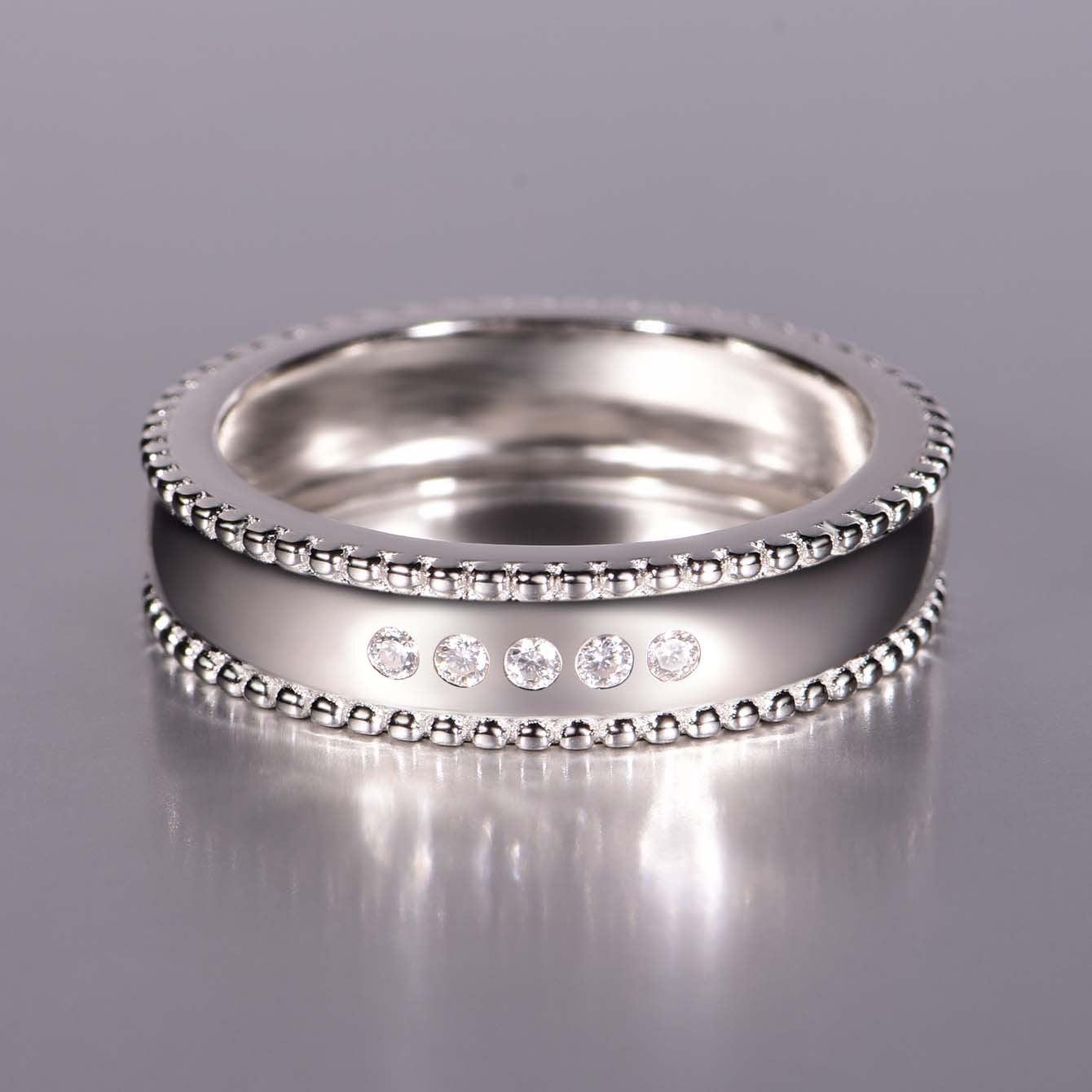 Men's wide S925 silver wedding ring with beaded edges and five D-color moissanite stones.