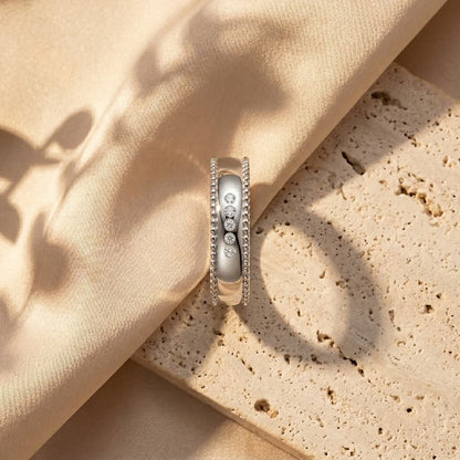 Men's wide S925 silver wedding ring with beaded edge and five D-color moissanite stones.