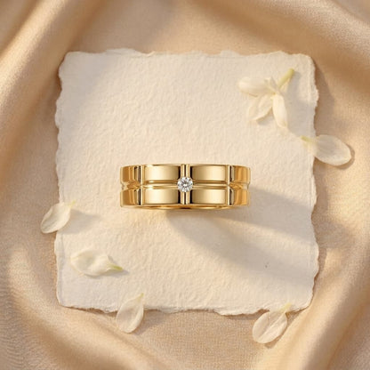 Gold wide band men's wedding ring with a grid pattern and a single D-color moissanite stone.