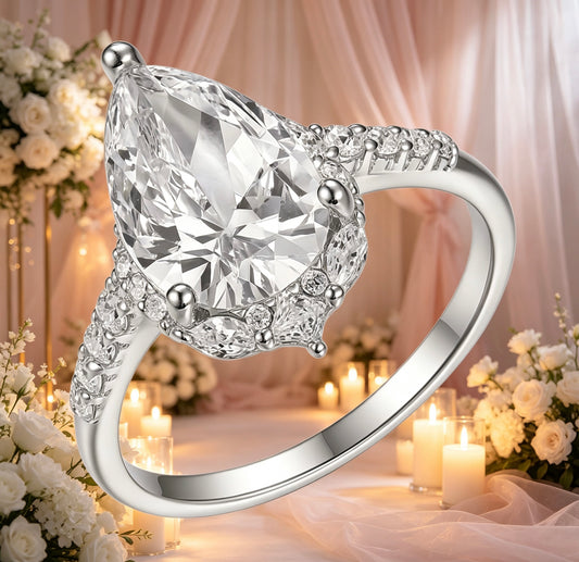 8x12mm pear-cut D color VVS1 moissanite halo ring with marquise and pavé accents on S925 silver.